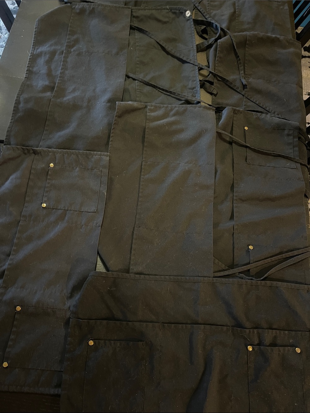 Large lot, black server, aprons
